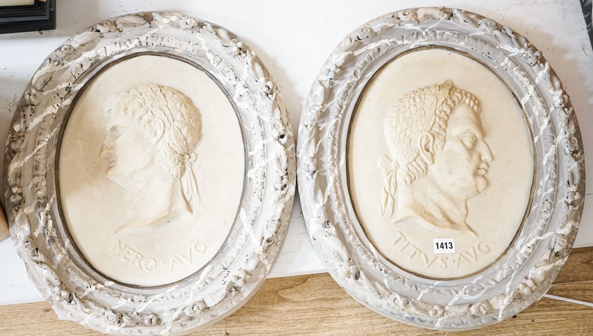 A decorative pair of faux marble portrait reliefs of Roman emperors 38cms